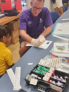 Dr Adam Craig conducting a national health survey in Niue.