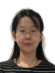 Smiling Asian woman wearing glasses and fringe crossing her forehead.