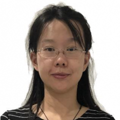 Smiling Asian woman wearing glasses and fringe crossing her forehead.